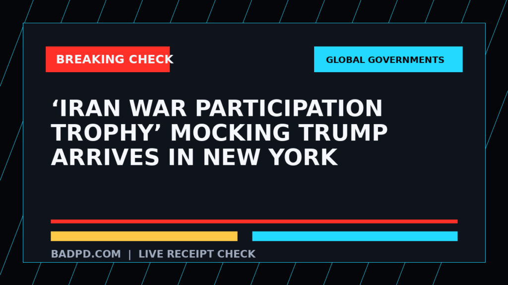 Symbolic editorial breaking-check graphic for ‘Iran War Participation Trophy’ mocking Trump arrives in New York, not a depiction of the event.